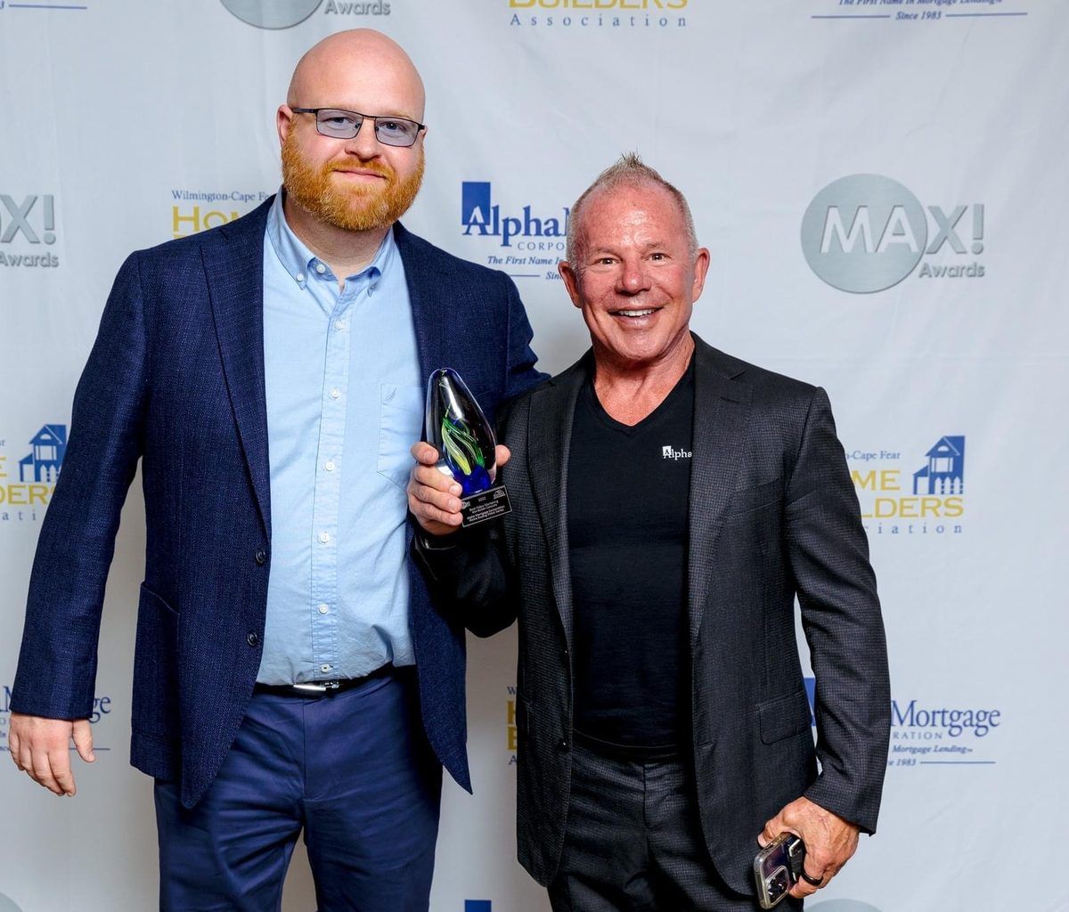 Nick Irmo accepting the 2022 MAX Award for Best Video Marketing with Alpha Mortgage president Michael Lopez